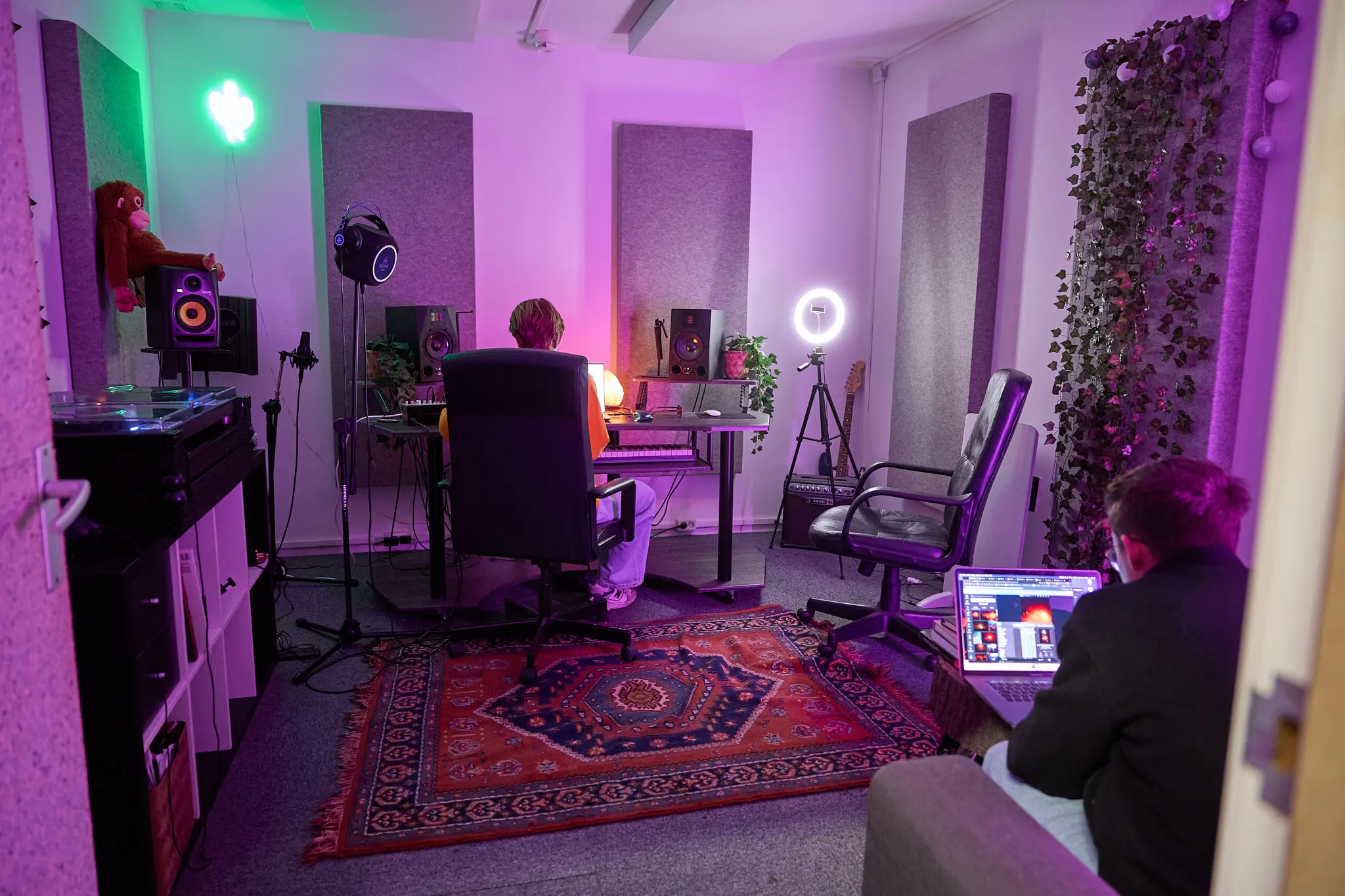 muziekstudio-huren-co-grote-voort donkere muziekstudio waar twee mensen aan het werk zijn